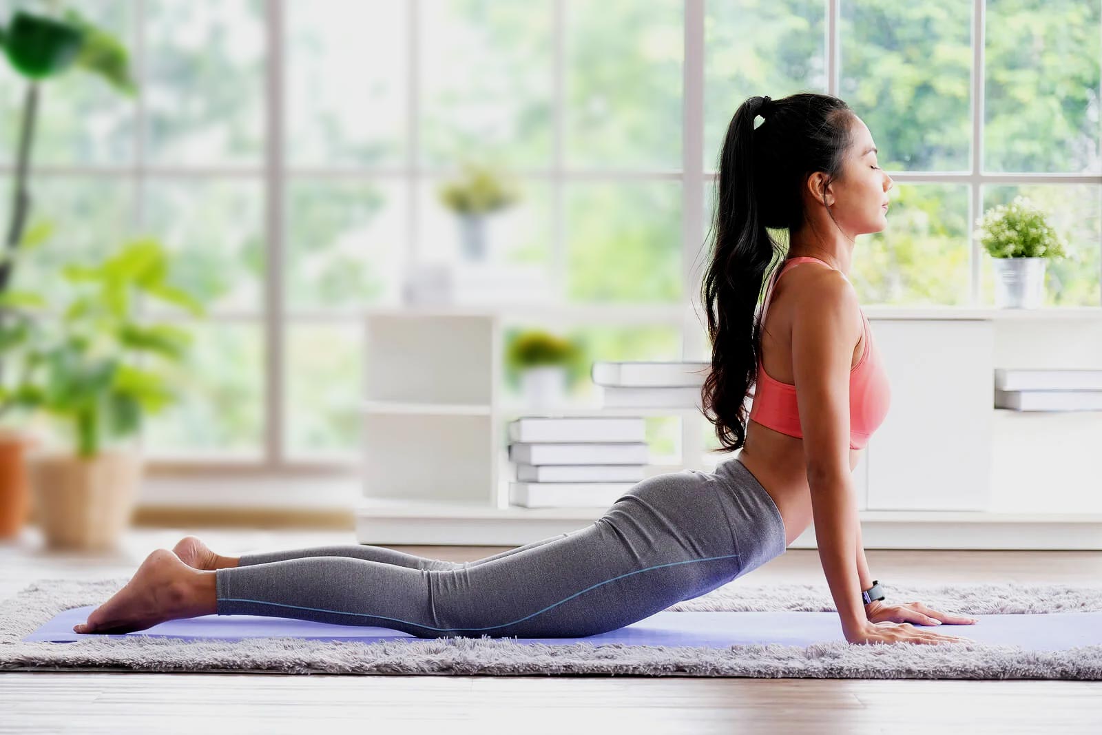Woman practicing yoga in a bright studio